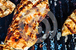 Chicken and pork steak grilled on a charcoal barbeque. Top view of camping tasty barbecue, food concept, food on grill and detail