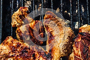 Chicken and pork steak grilled on a charcoal barbeque. Top view of camping tasty barbecue  food concept  food on grill and detail