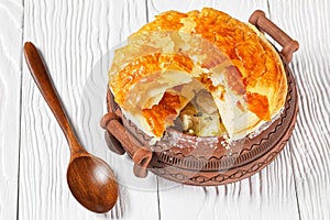 Chicken pot pie in a rustic clay pot