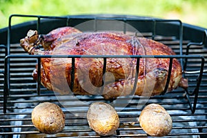 Chicken and potatoes baked and smoked on a kettle grill