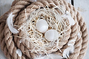 Easter, eggs, chicken eggs, quail eggs, eggs, rope, nest, white, feathers,in the hay
