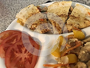 chicken quesadilla, with assorted vegetable medley, sliced tomatoes