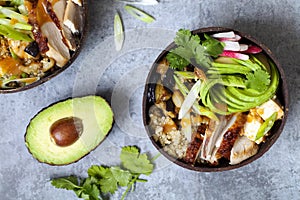 Chicken, quinoa and avocado in coconut bowl