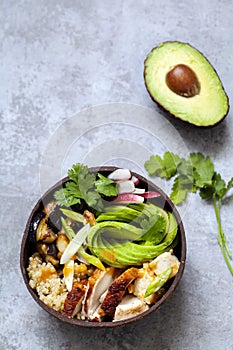 Chicken, quinoa and avocado in coconut bowl