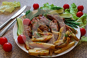 Chicken ribs in honey sauce with french fries and vegetables