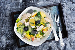 Chicken salad with eggs and vegetables on a plate