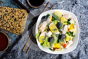 Chicken salad with eggs and vegetables on a plate