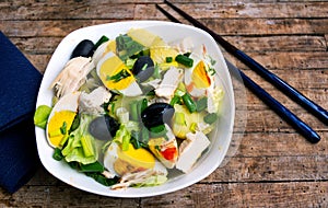 Chicken salad with eggs and vegetables on a plate