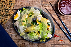 Chicken salad with eggs and vegetables on a plate