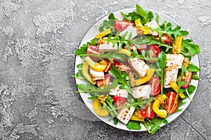 Chicken salad. Meat salad with fresh tomato, sweet pepper, arugula and grilled chicken breast. Chicken fillet with fresh vegetable