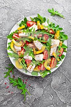 Chicken salad. Meat salad with fresh tomato, sweet pepper, arugula and grilled chicken breast. Chicken fillet with fresh vegetable