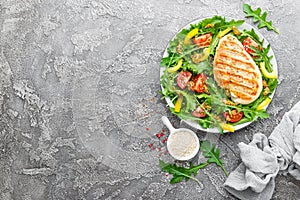 Chicken salad. Meat salad with fresh tomato, sweet pepper, arugula and grilled chicken breast. Chicken fillet with fresh vegetable