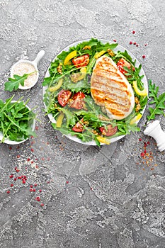 Chicken salad. Meat salad with fresh tomato, sweet pepper, arugula and grilled chicken breast. Chicken fillet with fresh vegetable