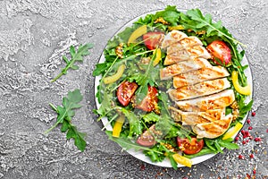 Chicken salad. Meat salad with fresh tomato, sweet pepper, arugula and grilled chicken breast. Chicken fillet with fresh vegetable