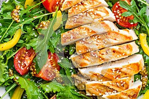 Chicken salad. Meat salad with fresh tomato, sweet pepper, arugula and grilled chicken breast. Chicken fillet with fresh vegetable