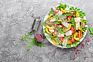 Chicken salad. Meat salad with fresh tomato, sweet pepper, arugula and grilled chicken breast. Chicken fillet with fresh vegetable