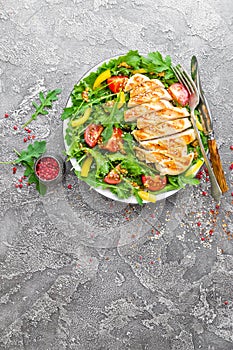 Chicken salad. Meat salad with fresh tomato, sweet pepper, arugula and grilled chicken breast. Chicken fillet with fresh vegetable