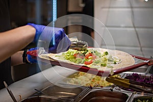 making a kebab in a restaurant chicken salad in rollo photo