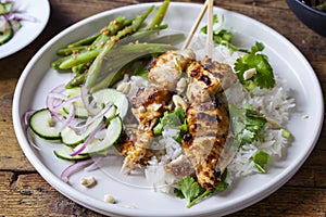 Chicken satay and cucumber salad, rice and green beans