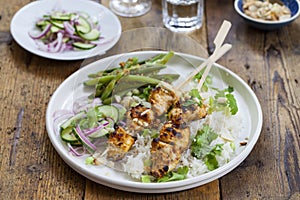 Chicken satay and cucumber salad, rice and green beans