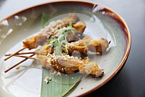 Chicken satay, sate ayam and lontong with peanut sauce