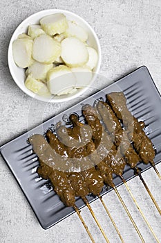 Chicken satay (sate ayam) with Lontong and peanut sauce