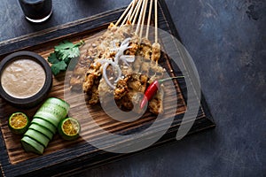 Chicken Satay or Sate Ayam - Malaysian famous food. Is a dish of seasoned, skewered and grilled meat, served with a