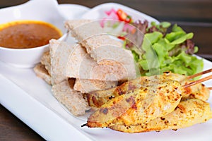 Chicken Satay ,Sate Ayam with Peanut Sauce and bread , Asian skewers famous food in Malaysia Indonesia and Thailand
