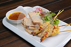 Chicken Satay served with Peanut Sauce and bread , Asian skewers