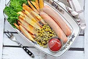 Chicken sausages with the fried potato, catchup and fresh lettuce