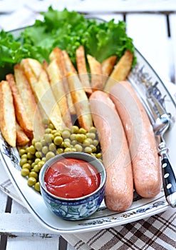Chicken sausages with the fried potato, catchup and fresh lettuce