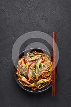 Chicken Schezwan Noodles or Hakka or Chow Mein in black bowl at dark background. Schezwan Noodles is indo-chinese cuisine hot dish