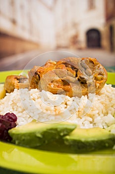 Chicken served with white rice potato on a plate