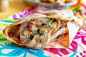 chicken shawarma readytoeat on a colorful paper wrap photo