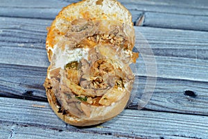 Chicken shawarma sandwich in a a bun, a popular Middle Eastern dish that originated in the Ottoman Empire, chicken cuts into thin