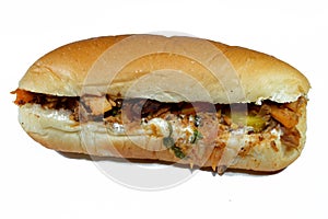 Chicken shawarma sandwich in a a bun, a popular Middle Eastern dish that originated in the Ottoman Empire, chicken cuts into thin