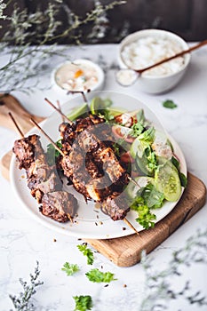 Chicken Shawarma Skewers with green Salad, Rice and Sauce. Middle Eastern Food