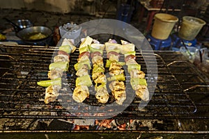 Chicken shish kabob being cooked at outdoor night street market