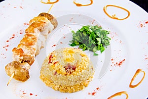 Chicken skewer: Chicken fillet, bell pepper, mushrooms, spicy couscous with vegetables and dried tomatoes with parsley