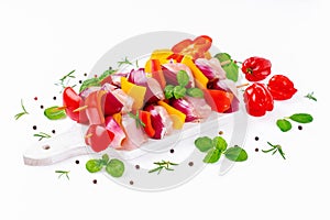 Chicken Skewers meat.Raw chicken leg meat skewers with vegetables,peppers, onions,white background.Uncooked mixed meat