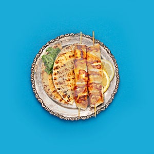 Chicken skewers souvlaki on color background