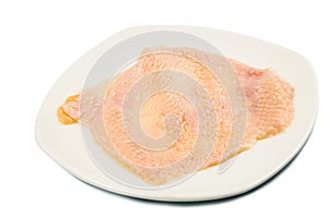 Chicken skin removed from breast meat on a plate photo