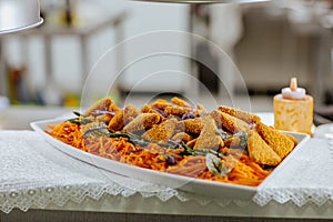 Chicken snacks and carrot on distribution desk in restaurant