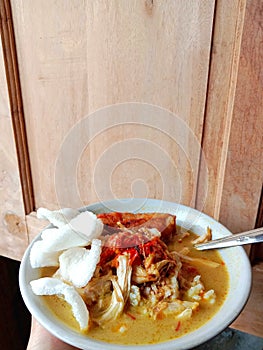 Chicken soup in a bowl. Soto ayam is a typical Indonesian food in the form of a type of chicken soup with a yellowish sauce.