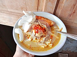 Chicken soup in a bowl. Soto ayam is a typical Indonesian food in the form of a type of chicken soup with a yellowish sauce.