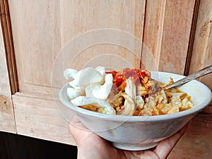 Chicken soup in a bowl. Soto ayam is a typical Indonesian food in the form of a type of chicken soup with a yellowish sauce.