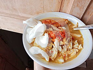 Chicken soup in a bowl. Soto ayam is a typical Indonesian food in the form of a type of chicken soup with a yellowish sauce.