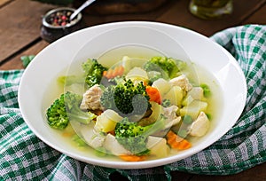 Chicken soup with broccoli, green peas, carrots and celery