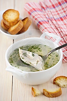 Chicken soup with herbs and toasts