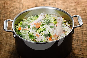 Chicken soup ingredients in cook pot